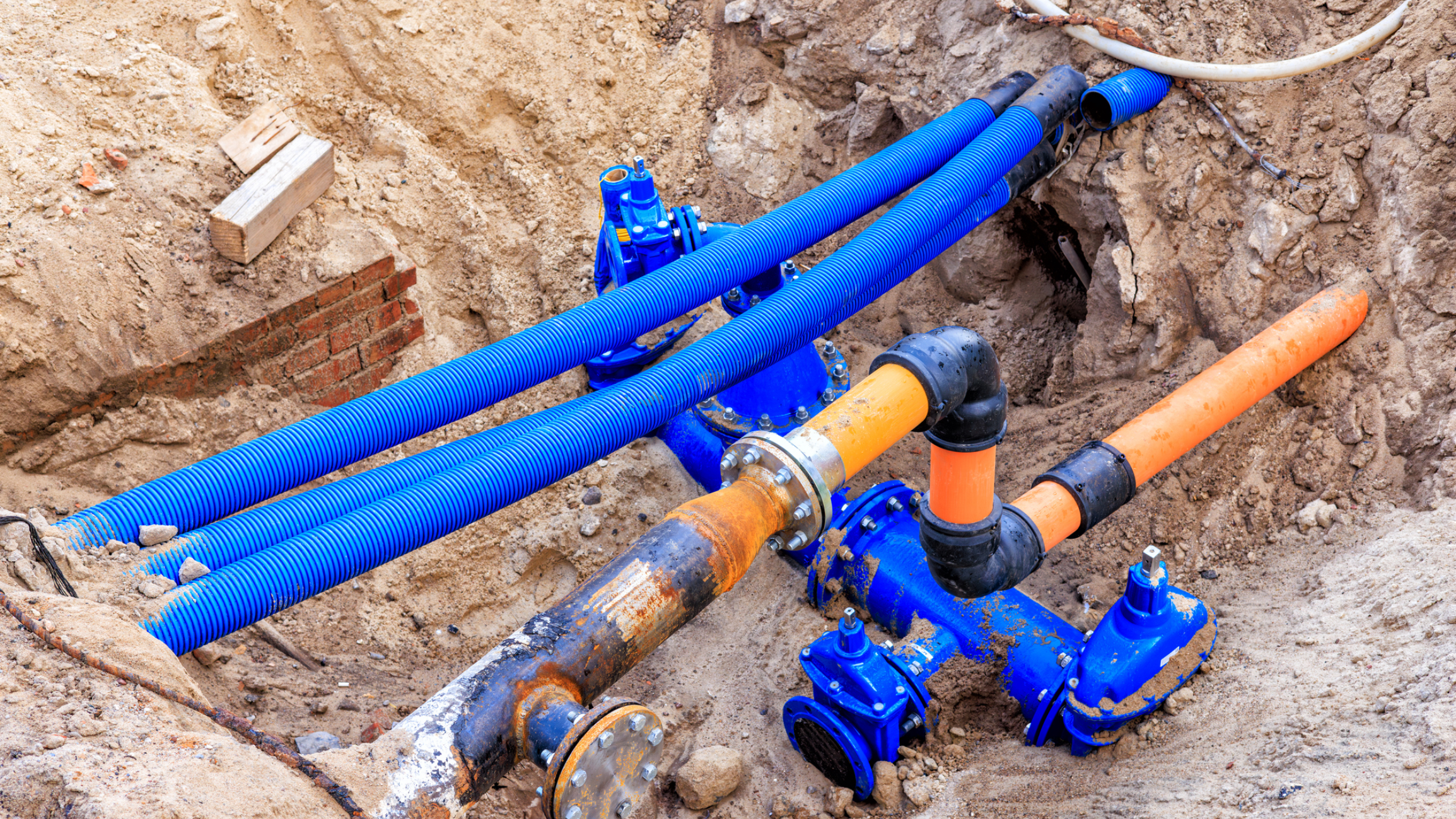 Underground pipes and valves in construction site.